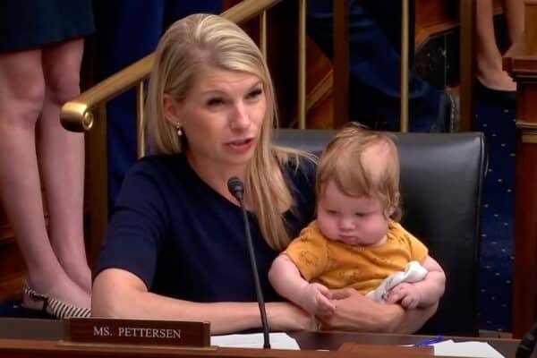 The Petterson representative brings Baby Son as he asks the president of the Fed Hearing at the audience