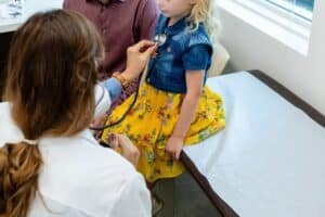 Photo: A doctor reviews a child in an office in a file photo without date.
